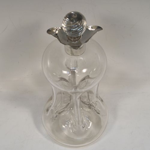 A very pretty Antique Victorian Sterling Silver and hand-cut crystal glug-glug decanter, having a plain body with four pinched and fluted central waists between, a plain round neck mount with four spouts, and a swirl fluted crystal stopper. This beautiful antique silver and crystal decanter was made by William Hammon of Chester in 1895. The dimensions of this fine hand-made antique silver and crystal glug glug decanter are height 21.5 cms (8.5 inches), and width at base 9 cms (3.5 inches).