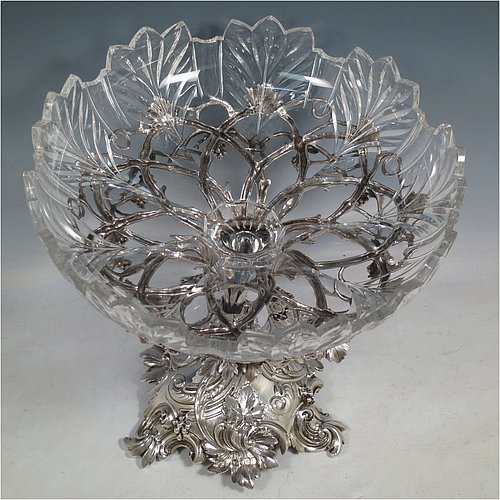 A very pretty Antique Victorian Sterling Silver compote or dessert stand with applied cast grape vine work, and sitting on a pedestal foot with hand-chased anthemion leaves, together with a hand-cut crystal bowl. Made by the Barnard Brothers of London in 1856. The dimensions of this fine hand-made antique silver and crystal dessert or compote stand are height 28 cms (11 inches), diameter of bowl 25.5 cms (10 inches), and it weighs approx. 1,273g (41 troy ounces).
