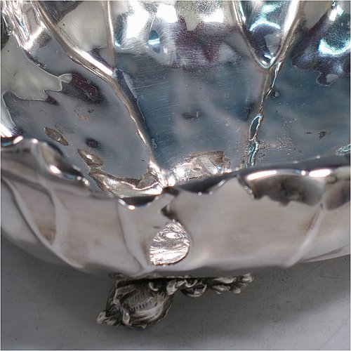 An Antique Victorian Silver Plated very unusual squirrel nut dish, having an oval body all hand-chased and made to look like half a walnut, with a cast squirrel handle, and sitting on four cast foliate feet. Made by the Pairpoint Brothers of Sheffield in ca. 1880. The dimensions of this fine hand-made antique silver-plated bread dish are length 28 cms (11 inches), width 19 cms (7.5 inches), and height 13 cms (5 inches).
