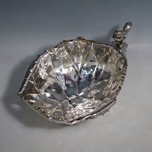 An Antique Victorian Silver Plated very unusual squirrel nut dish, having an oval body all hand-chased and made to look like half a walnut, with a cast squirrel handle, and sitting on four cast foliate feet. Made by the Pairpoint Brothers of Sheffield in ca. 1880. The dimensions of this fine hand-made antique silver-plated bread dish are length 28 cms (11 inches), width 19 cms (7.5 inches), and height 13 cms (5 inches).