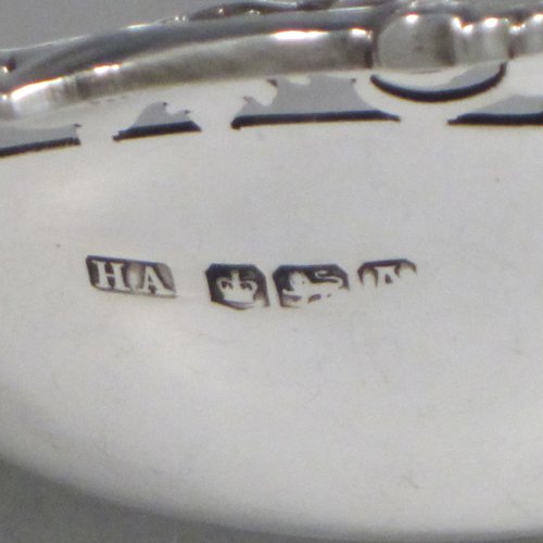 Sterling silver dish, having a shaped and lobed round body, with an applied and hand-pierced border showing grape-vine and leaf decoration, and sitting on a flat base. Made by Henry Atkins of Sheffield in 1943. The dimensions of this fine hand-made silver dish are diameter 23 cms (9 inches), height 5 cms (2 inches), and it weighs approx. 387g (12.8 troy ounces).