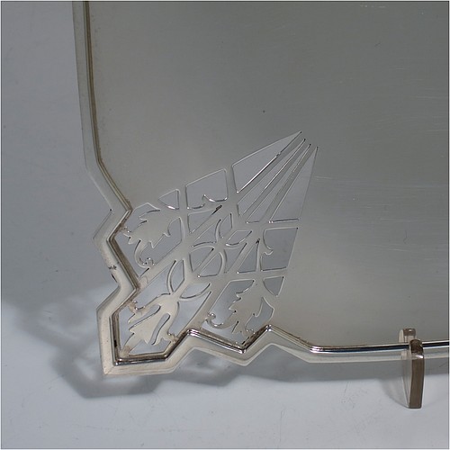 A Sterling Silver Art Deco very elegant style serving dish, having a square-shaped slightly concave body, with hand-pierced geometrical corners, and sitting on a pedestal foot. Made by Mappin and Webb of Sheffield in 1935. The dimensions of this fine hand-made sterling silver Art Deco dish are 23 cms (9 inches) square, height 2.5 cms (1 inch), and it weighs approx. 430g (13.9 troy ounces).