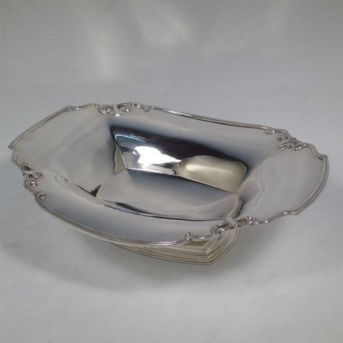 A handsome Sterling Silver Art Deco serving dish, having a panelled body, with an applied reed and scroll border, and sitting on a stepped pedestal foot. Made by Manoah Rhodes and Sons Ltd., of London in 1923. The dimensions of this fine hand-made silver Art Deco dish are length 26 cms (10.25 inches), width 20 cms (8 inches), height 7 cms (2.75 inches), and it weighs approx. 470g (15 troy ounces).