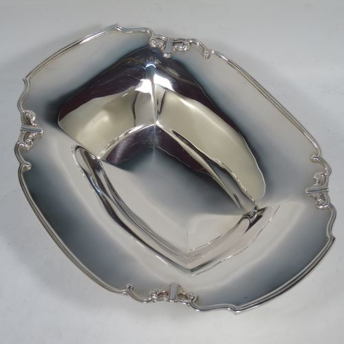 A handsome Sterling Silver Art Deco serving dish, having a panelled body, with an applied reed and scroll border, and sitting on a stepped pedestal foot. Made by Manoah Rhodes and Sons Ltd., of London in 1923. The dimensions of this fine hand-made silver Art Deco dish are length 26 cms (10.25 inches), width 20 cms (8 inches), height 7 cms (2.75 inches), and it weighs approx. 470g (15 troy ounces).