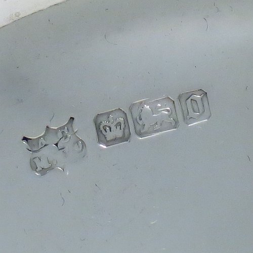 An Antique Edwardian Sterling Silver serving dish, having a round body, with an applied cast scroll and shell border, a hand-pierced body with floral decoration, and sitting on a plain flat collet foot. Made by Alexander Clark of Sheffield in 1906. The dimensions of this fine hand-made antique silver serving dish are 27 cms (10.5 inches) diameter, height 6 cms (2.3 inches), and it weighs approx. 460g (14.8 troy ounces).