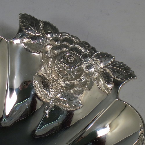 A very pretty Antique Victorian Sterling Silver strawberry dish, having an oval lobed body, with cast and hand-chased handles in the shape of roses, and sitting on a collet foot. Made by William Robert Smily of London in 1853. The dimensions of this fine hand-made antique strawberry table dish are length 24 cms (9.5 inches), width 19 cms ((7.5 inches), height 4 cms (1.5 inches), and it weighs approx. 316g (10.2 troy ounces).
