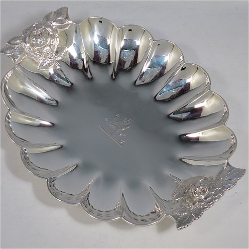 A very pretty Antique Victorian Sterling Silver strawberry dish, having an oval lobed body, with cast and hand-chased handles in the shape of roses, and sitting on a collet foot. Made by William Robert Smily of London in 1853. The dimensions of this fine hand-made antique strawberry table dish are length 24 cms (9.5 inches), width 19 cms ((7.5 inches), height 4 cms (1.5 inches), and it weighs approx. 316g (10.2 troy ounces).