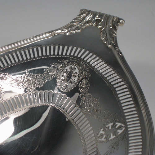 A pretty Antique Edwardian Sterling Silver oval pierced dish with neoclassical style decoration. This beautiful antique silver bread roll dish was made by Thomas Bradbury & Sons of Sheffield in 1910. The dimensions of this fine hand-made silver oval dish are length 32 cms (12.5 inches), width 17.5 cms (7 inches), height 9 cms (3.5 inches), and it weighs approx. 403g (13 troy ounces).
