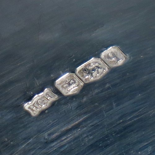 A Sterling Silver Arts and Crafts style dish, having an oval body with hand-hammered decoration, an applied rope-twist border, with hand-chased floral and scroll work at either ends, and all sitting on a collet foot. Made by Henry Charles Hall (from the Swansea School of Crafts) of Sheffield in 1932. The dimensions of this fine hand-made silver table dish are length 31 cms (12.25 inches), width 21 cms (8.25 inches), height 4 cms (1.5 inches), and it weighs approx. 464g (15 troy ounces).