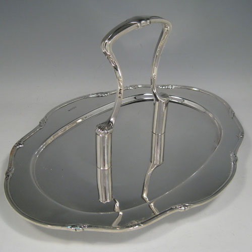 A heavy and very stylish Art Deco Sterling Silver unusual flat serving dish with carrier handle, with an applied reeded and floral border, all sitting on four cast flange feet. This unique silver serving dish was made by Charles Boyton & Sons of Sheffield in 1931. The dimensions of this fine hand-made serving dish are height 19 cms (7.5 inches), length 34.5 cms (13.5 inches), width 26 cms (10.25 inches), and it weighs approx. 1,156g (37.2 troy ounces).