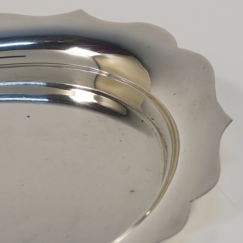 An elegant Sterling Silver condiment or bon-bon dish, having a plain oval body with a raised Chippendale style border, and sitting on a flat base. This handsome silver condiment dish was made by Emile Viner of Sheffield in 1938. The dimensions of this fine hand-made silver dish are length 15 cms (6 inches), width 11.5 cms (4.5 inches), and it weighs approx. 127g (4 troy ounces).