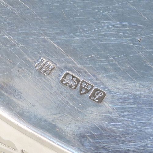 A very pretty Antique Sterling Silver bread roll table dish, having an oval body with hand-pierced geometrical and floral style decoration, an applied gadroon top border, and sitting on a flat base. This beautiful antique silver bread roll dish was made by the Barker Brothers of Chester in 1911. The dimensions of this fine hand-made silver bread dish are length 30 cms (11.75 inches), width 17.5 cms (7 inches), height 7.5 cms (3 inches), and it weighs approx. 389g (12.5 troy ounces).