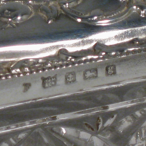    Antique Edwardian sterling silver and crystal dressing table jar / box, having a pull-off lid with hand-chased floral decoration, and a rectangular hand-cut crystal body. Made in Birmingham in 1906. Length 12 cms (4.75 inches), width 4.5 cms (1.75 inches), height 4 cms (1.5 inches).