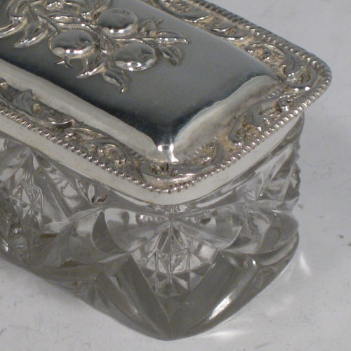    Antique Edwardian sterling silver and crystal dressing table jar / box, having a pull-off lid with hand-chased floral decoration, and a rectangular hand-cut crystal body. Made in Birmingham in 1906. Length 12 cms (4.75 inches), width 4.5 cms (1.75 inches), height 4 cms (1.5 inches).