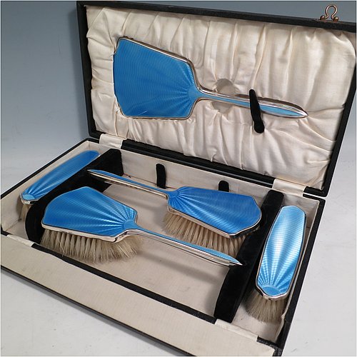 A Sterling Silver and light blue enamelled Art Deco style dressing table set with five pieces, consisting of a hand-mirror with original bevelled mirror, two clothes brushes, and two hair brushes, all with original bristles, and all in their original black velvet and cream satin-lined presentation box. Made by W. G. Sothers Ltd., of Birmingham in 1931. The dimensions of this fine hand-made sterling silver and enamelled dressing table service are length of hand mirror 26.5 cms (10.5 inches), length of hair brush 23.5 cms (9.25 inches), and length of clothes brush 14.5 cms (5.75 inches).