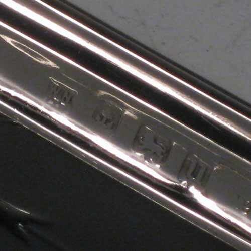 Sterling silver dressing table pin tray, having a shaped elongated oval body, with hand-chased neoclassical floral decoration. Made by William Naylor of Birmingham in 1919. The dimensions of this fine hand-made silver pin tray are length 23.5 cms (9.25 inches), width 9 cms (3.5 inches), and it weighs approx. 87g (2.8 troy ounces).   