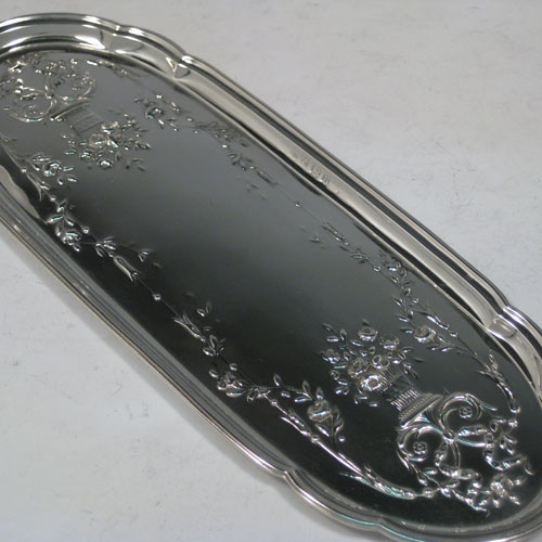 Sterling silver dressing table pin tray, having a shaped elongated oval body, with hand-chased neoclassical floral decoration. Made by William Naylor of Birmingham in 1919. The dimensions of this fine hand-made silver pin tray are length 23.5 cms (9.25 inches), width 9 cms (3.5 inches), and it weighs approx. 87g (2.8 troy ounces).   