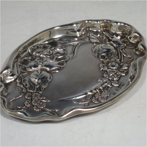 An Antique Edwardian Art Nouveau Sterling Silver small dressing table pin tray, having a shaped oval body with hand-chased floral decoration, a central vacant cartouche, and all sitting on a flat base. Made by Thomas Bishton of Birmingham in 1908. The dimensions of this fine hand-made antique silver pin tray are length 13.5 cms (5.3 inches), width 9.5 cms (3.75 inches), and it weighs approx. 47g (1.5 troy ounces).