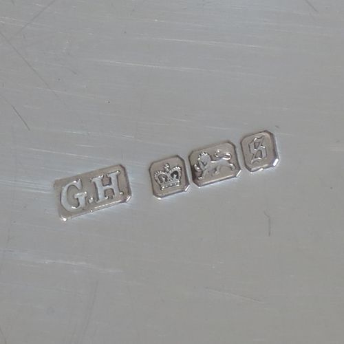 A pretty Antique Edwardian Sterling Silver dressing table tray, having a rectangular body with rounded corners, a plain ground, an applied laurel-leaf and reeded border, and all sitting on a flat base. Made by Harrison Brothers and Howson of Sheffield in 1910. The dimensions of this fine hand-made ique antsilver dressing table tray are length 30 cms (12 inches), width 22 cms (8.75 inches), and it weighs approx. 512g (16.5 troy ounces).    