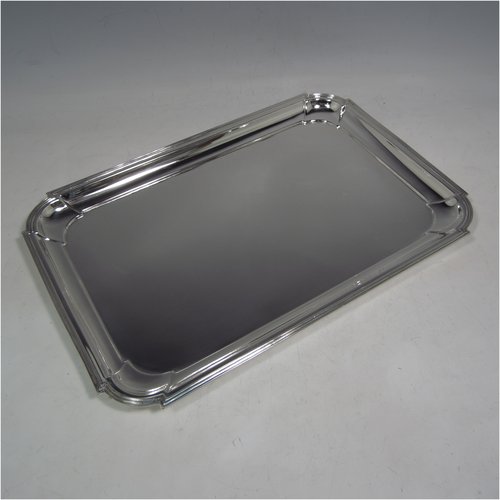 A Sterling silver Art Deco dressing table tray, having a rectangular body with cut corners, a plain ground, an applied reeded border, and sitting on a flat base. Made by A. & J. Zimmerman of Birmingham in 1929. The dimensions of this fine hand-made silver dressing table tray are length 31 cms (12.75 inches), width 21 cms (8.25 inches), and it weighs approx. 495g (16 troy ounces).