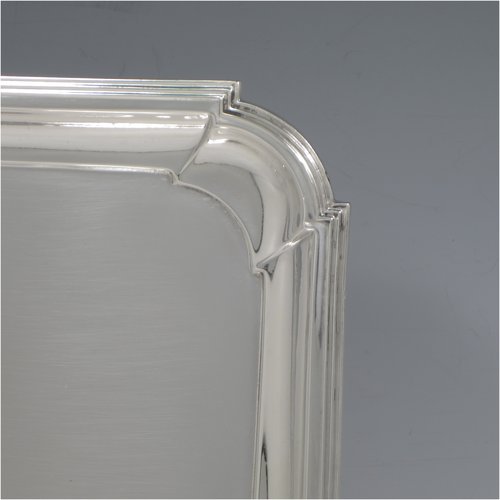 A Sterling silver Art Deco dressing table tray, having a rectangular body with cut corners, a plain ground, an applied reeded border, and sitting on a flat base. Made by A. & J. Zimmerman of Birmingham in 1929. The dimensions of this fine hand-made silver dressing table tray are length 31 cms (12.75 inches), width 21 cms (8.25 inches), and it weighs approx. 495g (16 troy ounces).