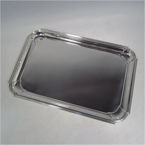 A Sterling silver Art Deco dressing table tray, having a rectangular body with cut corners, a plain ground, an applied reeded border, and sitting on a flat base. Made by A. & J. Zimmerman of Birmingham in 1929. The dimensions of this fine hand-made silver dressing table tray are length 31 cms (12.75 inches), width 21 cms (8.25 inches), and it weighs approx. 495g (16 troy ounces).