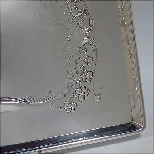 A very pretty Antique Edwardian Sterling Silver Art Nouveau style dressing table pin tray, having a rectangular body with hand-chased floral and ribbon work, a raised plain outer border, and all sitting on a flat base. Made by Charles H. Dumeril of London in 1907. The dimensions of this fine hand-made antique silver pin tray are length 32 cms (12.5 inches), width 23 cms (9 inches), and it weighs approx. 584g (18.8 troy ounces).    