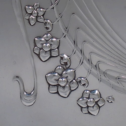 A very pretty Antique Edwardian Sterling Silver Art Nouveau style dressing table pin tray, having a rectangular body with hand-chased floral and ribbon work, a raised plain outer border, and all sitting on a flat base. Made by Charles H. Dumeril of London in 1907. The dimensions of this fine hand-made antique silver pin tray are length 32 cms (12.5 inches), width 23 cms (9 inches), and it weighs approx. 584g (18.8 troy ounces).    