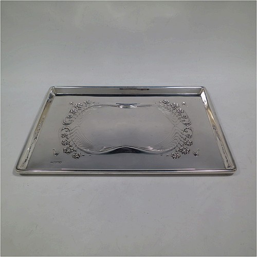 A very pretty Antique Edwardian Sterling Silver Art Nouveau style dressing table pin tray, having a rectangular body with hand-chased floral and ribbon work, a raised plain outer border, and all sitting on a flat base. Made by Charles H. Dumeril of London in 1907. The dimensions of this fine hand-made antique silver pin tray are length 32 cms (12.5 inches), width 23 cms (9 inches), and it weighs approx. 584g (18.8 troy ounces).    