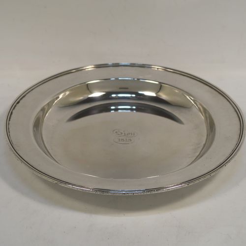 A very handsome pair of Antique Georgian Old Sheffield Plated offertory or alms dishes, having plain round bodies, with applied reeded borders, and all sitting on three button feet. These elegant Old Sheffield Plated alms or offertory dishes were made in ca. 1815. The dimensions of this fine pair of hand-made antique Old Sheffield Plated Alms dishes are are diameter 24 cms (9.55 inches), and height 3 cms (1.25 inches). Please note that these items are engraved with Sion 1818.