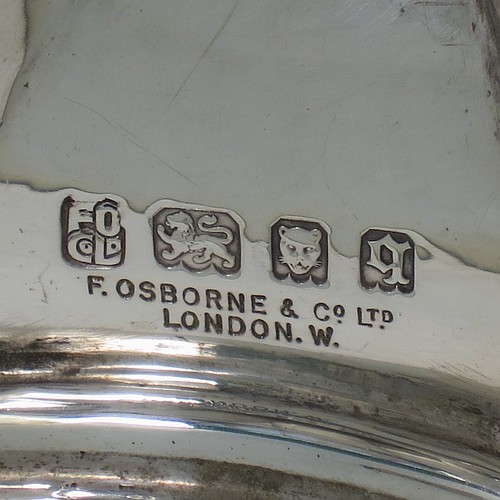 A Sterling Silver altar chalice and paten, having a plain round tapering cup with gold-gilt interior, a round column with a middle baluster and bead border, and a spreading hexagonal pedestal foot, together with a plain round paten with hand-engraved cross. The chalice made by Frederick Osborne of London in 1931, and the paten by Jones and Willis of London in 1908. The dimensions of this fine hand-made silver chalice & paten are height 15 cms (6 inches), diameter of cup 10 cms (4 inches), diameter of paten 13.5 cms (5.3 inches), and it weighs a total of 455g (14.7 troy ounces).