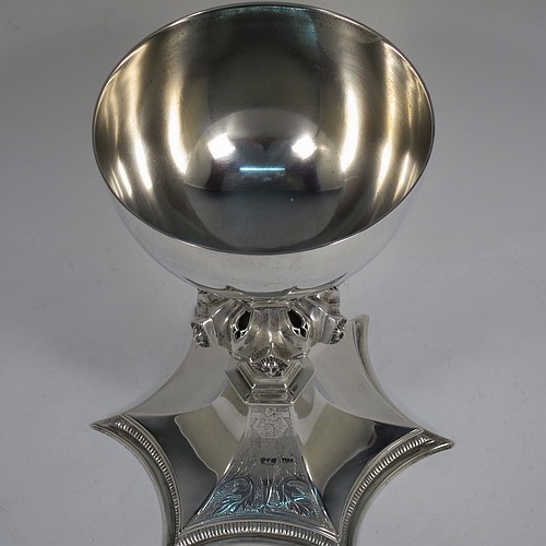 A large and heavy Antique Edwardian Sterling Silver altar chalice, having a plain round bellied cup, an octagonal column with middle baluster having hand-pierced decoration and applied leopards heads, and a spreading concave octagonal foot with a gadroon lower borer. Made by Frederick Wray of London in 1910. The dimensions of this fine hand-made antique silver altar chalice are height 20 cms (8 inches), diameter of cup 12cms (4.75 inches), across foot 16 cms (6.3 inches), and it weighs approx. 584g (18.8 troy ounces).