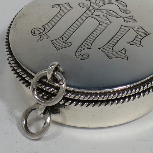 A handsome Sterling Silver Pyx box, having a plain round body with applied rope-twist borders, a hinged lid with a hand-engraved Christogram, a gold-gilt interior, and with a pair of ring handles. Made by B. & W. Ltd., of London in 1960. The dimensions of this fine hand-made silver Pyx box are diameter 5 cms (2 inches), depth 2 cms (0.5 inches), and it weighs approx. 52g (1.7 troy ounces).