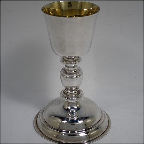 A very handsome Sterling Silver altar chalice and paten, having a plain round tapering cup with a gold-gilt interior, a middle plain round stepped baluster, sitting on a round stepped pedestal foot, and a matching plain round paten with the upper side gold-gilt. The chalice made by J. S. Harman of London in 1933, and the paten made by G.M.B. of London in 1972. The dimensions of this fine hand-made silver chalice and paten are height of chalice 16 cms (6.25 inches), diameter of paten 11.5 cms (4.5 inches), and with a total weight of approx. 330g (10.6 troy ounces).