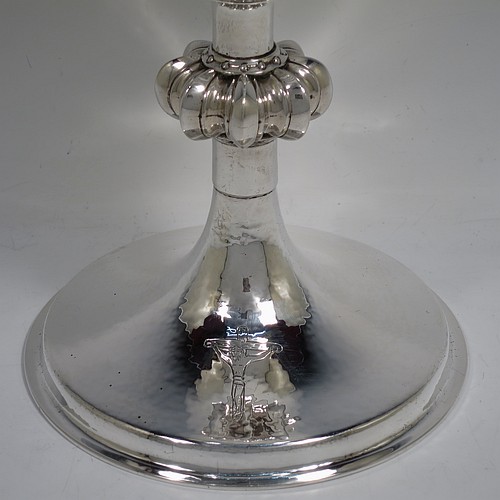 A large and handsome Sterling Silver altar chalice, having a round hand-hammered tapering cup, a middle hand-chased octagonal style baluster with upper and lower applied beaded bands, and a spreading pedestal foot, again hand-hammered and with an engraved Christ on the Cross. Made by A. R. Mowbray and Co., Ltd., of London in 1936. The dimensions of this fine hand-made silver chalice are height 20 cms (8 inches), diameter at base 15 cms (6 inches), and it weighs approx. 581g (18.7 troy ounces).