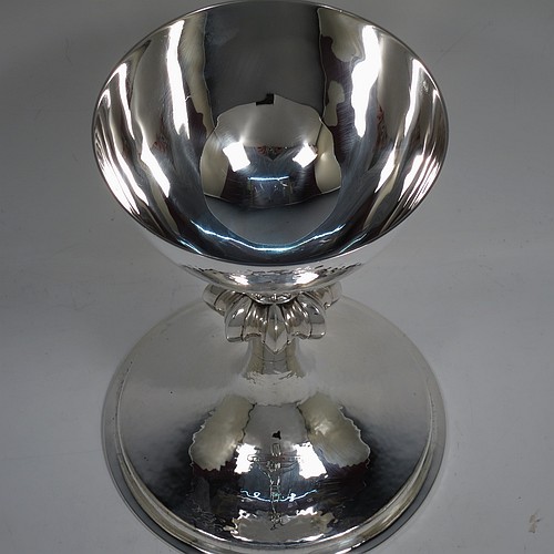 A large and handsome Sterling Silver altar chalice, having a round hand-hammered tapering cup, a middle hand-chased octagonal style baluster with upper and lower applied beaded bands, and a spreading pedestal foot, again hand-hammered and with an engraved Christ on the Cross. Made by A. R. Mowbray and Co., Ltd., of London in 1936. The dimensions of this fine hand-made silver chalice are height 20 cms (8 inches), diameter at base 15 cms (6 inches), and it weighs approx. 581g (18.7 troy ounces).