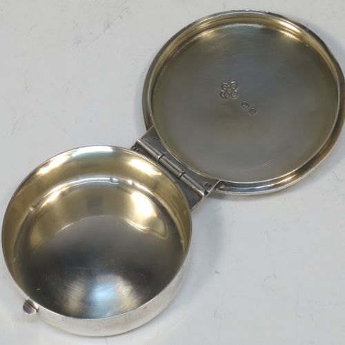 A large and very handsome Sterling Silver Pyx box, having a plain round body, a hinged lid with a hand-engraved Christogram over a cross, a gold-gilt interior, and a clasp with ring handle. Made by Burns, Oats, and Washbourne of London in 1930. The dimensions of this fine hand-made silver Pyx box are diameter 5 cms (2 inches), depth 1.5 cms (0.5 inches), and it weighs approx. 33g (1 troy ounce).