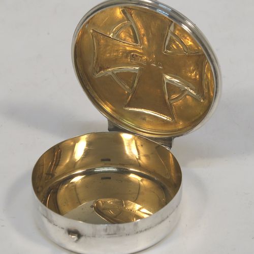 A large and very handsome Sterling Silver Pyx box, having a plain round body with an applied reeded top border, a hinged lid with a hand-chased Cruciform Christogram, a ring-handle and thumb-piece, and a gold-gilt interior. This elegant silver pyx box was made by A. R. Mowbray and Co. Ltd., of London in 1946. The dimensions of this fine hand-made silver Pyx box are diameter 5 cms (2 inches), depth 1.5 cms (0.6 inches), and it weighs approx. 31g (1 troy ounce).