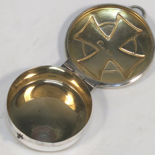 A large and very handsome Sterling Silver Pyx box, having a plain round body with an applied reeded top border, a hinged lid with a hand-chased Cruciform Christogram, a ring-handle and thumb-piece, and a gold-gilt interior. This elegant silver pyx box was made by A. R. Mowbray and Co. Ltd., of London in 1946. The dimensions of this fine hand-made silver Pyx box are diameter 5 cms (2 inches), depth 1.5 cms (0.6 inches), and it weighs approx. 31g (1 troy ounce).