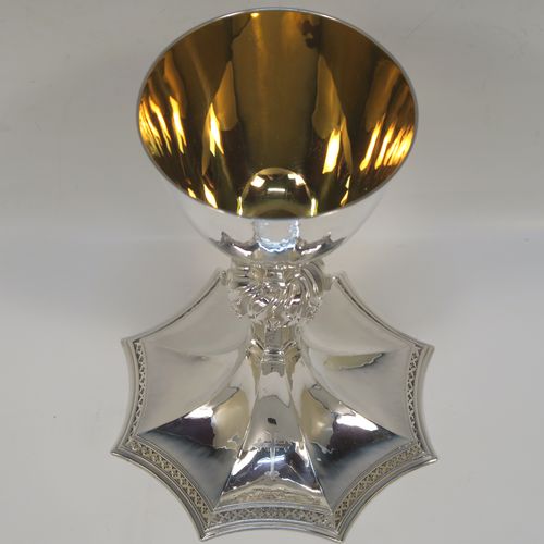 A large and handsome Sterling Silver altar chalice having a hand-hammered or planished finish, with a round tapering cup and a gold-gilt interior, an octagonal panelled stem with a central applied jewel-like baluster, and all sitting on a spreading octagonal panelled base with an applied fleur-de-lis border. This beautiful and impressive silver altar chalice was made made by A. R. Mowbray and Co., Ltd., of London in 1948. The dimensions of this fine hand-made silver chalice are height 20 cms (8 inches), diameter at lip of cup 10 cms (4 inches), spread across base 15 cms (6 inches), and it weighs approx. 444g (14.3 troy ounces).