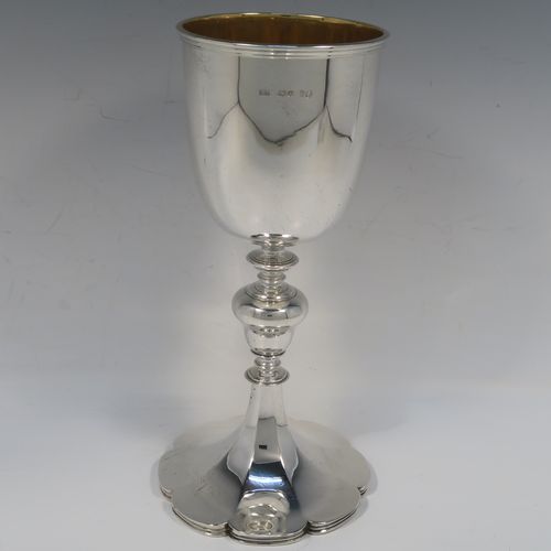 A large and handsome Antique early Victorian Sterling Silver chalice, having a plain round tapering body with a gold-gilt interior and an applied reeded top border, a stem with a round middle baluster, and sitting on a spreading panelled octofoil pedestal foot. This large and beautiful silver chalice was made by Robert Hennell III of London in 1842. The dimensions of this fine hand-made antique silver chalice are height 24.5 cms (9.75 inches), diameter at lip 10 cms (4 inches), and it weighs approx. 451g (14.5 troy ounces).   