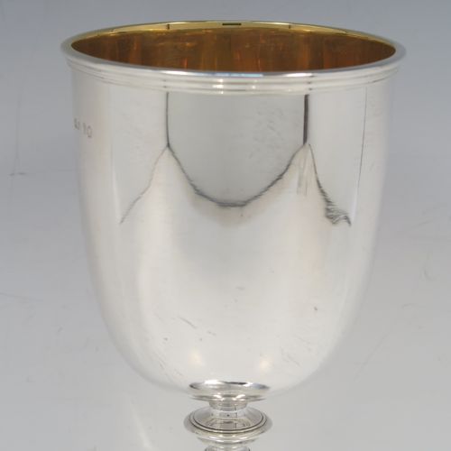A large and handsome Antique early Victorian Sterling Silver chalice, having a plain round tapering body with a gold-gilt interior and an applied reeded top border, a stem with a round middle baluster, and sitting on a spreading panelled octofoil pedestal foot. This large and beautiful silver chalice was made by Robert Hennell III of London in 1842. The dimensions of this fine hand-made antique silver chalice are height 24.5 cms (9.75 inches), diameter at lip 10 cms (4 inches), and it weighs approx. 451g (14.5 troy ounces).   
