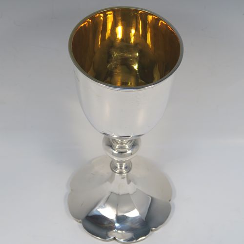 A large and handsome Antique early Victorian Sterling Silver chalice, having a plain round tapering body with a gold-gilt interior and an applied reeded top border, a stem with a round middle baluster, and sitting on a spreading panelled octofoil pedestal foot. This large and beautiful silver chalice was made by Robert Hennell III of London in 1842. The dimensions of this fine hand-made antique silver chalice are height 24.5 cms (9.75 inches), diameter at lip 10 cms (4 inches), and it weighs approx. 451g (14.5 troy ounces).   