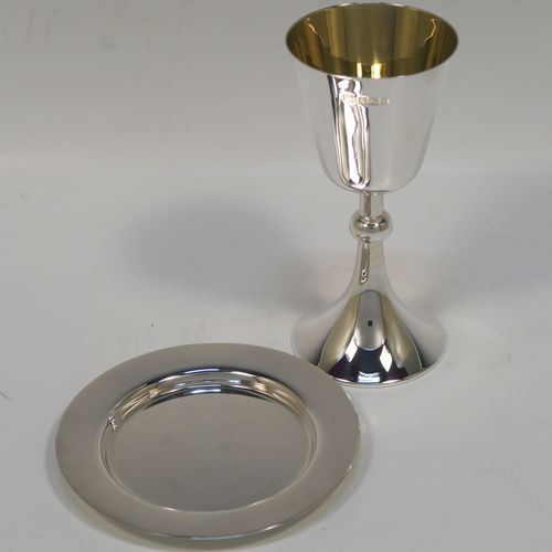 An elegant Antique Sterling Silver travelling communion chalice, having a plain round tapering cup with a gold-gilt interior, a round column with a middle baluster, and a spreading round pedestal foot, together with a matching plain round paten. The chalice was made by the Dixon Brothers of Sheffield in 1911, whilst the paten was made by A. E. Jones of Sheffield in 1962. The dimensions of this fine hand-made antique silver chalice & paten are height of chalice 12 cms (4.75 inches), diameter of paten 10 cms (4 inches), and the total weight is 137g (4.4 troy ounces).