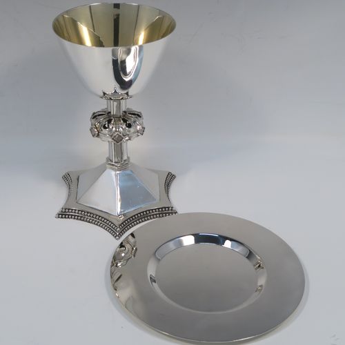 A very handsome Antique Victorian Sterling Silver altar chalice and paten. The chalice having a round tapering cup and lemon gold-gilt interior, an octagonal panelled stem with a central applied jewel-like baluster, and all sitting on a spreading octagonal panelled base with an applied double bead-edged border. This beautiful silver altar chalice was made made by William Gibson and John Langland of London in 1899. The paten which has a very plain round body was made by Goldsmiths and Silversmiths of London in 1900. The dimensions of this fine hand-made antique silver chalice are height 16.5 cms (6.5 inches), diameter at lip of cup 10 cms (4 inches), spread across base 12.5 cms (5 inches), diameter of paten 15 cms (6 inches), with a total weight of approx. 465g (15 troy ounces).