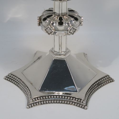 A very handsome Antique Victorian Sterling Silver altar chalice and paten. The chalice having a round tapering cup and lemon gold-gilt interior, an octagonal panelled stem with a central applied jewel-like baluster, and all sitting on a spreading octagonal panelled base with an applied double bead-edged border. This beautiful silver altar chalice was made made by William Gibson and John Langland of London in 1899. The paten which has a very plain round body was made by Goldsmiths and Silversmiths of London in 1900. The dimensions of this fine hand-made antique silver chalice are height 16.5 cms (6.5 inches), diameter at lip of cup 10 cms (4 inches), spread across base 12.5 cms (5 inches), diameter of paten 15 cms (6 inches), with a total weight of approx. 465g (15 troy ounces).