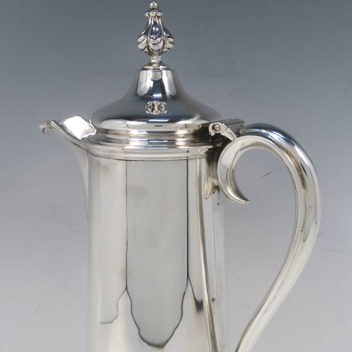 A handsome and large Antique Victorian Sterling Silver ecclesiastical wine flagon ewer, having a round straight-sided body with tapering sides and applied reeded bands, a side scroll handle, together with a hinged domed lid and cast fluted finial, a sparrow-beak spout, and sitting on a spreading collet foot. This elegant silver church consecrated wine flagon was made by the Barnard Brothers of London in 1850. The dimensions of this fine hand-made antique silver flagon or ewer are height 34.5 cms (13.5 inches), diameter at base 14.5 cms (5.75 inches), and it weighs approx. 980g (31.6 troy ounces).