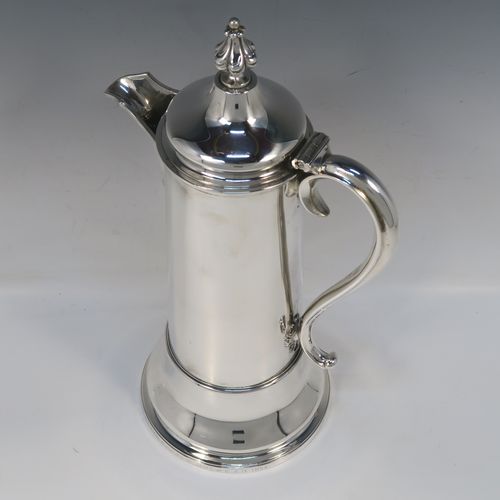 A handsome and large Antique Victorian Sterling Silver ecclesiastical wine flagon ewer, having a round straight-sided body with tapering sides and applied reeded bands, a side scroll handle, together with a hinged domed lid and cast fluted finial, a sparrow-beak spout, and sitting on a spreading collet foot. This elegant silver church consecrated wine flagon was made by the Barnard Brothers of London in 1850. The dimensions of this fine hand-made antique silver flagon or ewer are height 34.5 cms (13.5 inches), diameter at base 14.5 cms (5.75 inches), and it weighs approx. 980g (31.6 troy ounces).