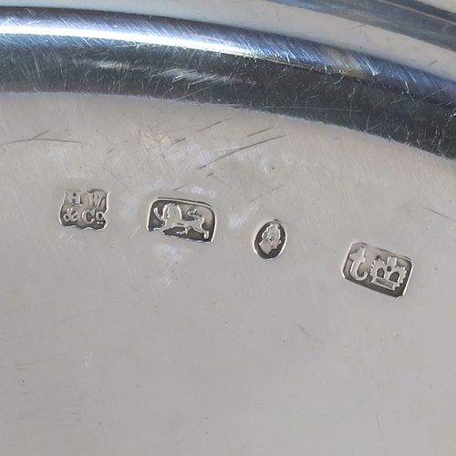 A very handsome Antique early Victorian Sterling Silver offertory or alms dish, having a round body, with an applied reeded border, a hand-engraved ground with sun-burst work surrounding a central Christogram, and all sitting on a flat base. This elegant antique silver alms or offertory dish was made by Henry Wilkinson of Sheffield in 1839. The dimensions of this fine hand-made silver offertory dish are diameter 23 cms (9 inches), and it weighs approx. 475g (15.3 troy ounces).
