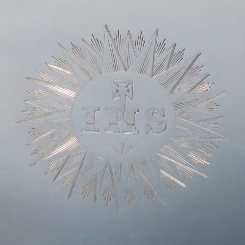 A very handsome Antique early Victorian Sterling Silver offertory or alms dish, having a round body, with an applied reeded border, a hand-engraved ground with sun-burst work surrounding a central Christogram, and all sitting on a flat base. This elegant antique silver alms or offertory dish was made by Henry Wilkinson of Sheffield in 1839. The dimensions of this fine hand-made silver offertory dish are diameter 23 cms (9 inches), and it weighs approx. 475g (15.3 troy ounces).